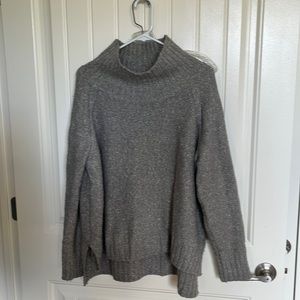 H&M gray sweater with wide turtleneck and vented sides. Hits mid hip Size L. EUC